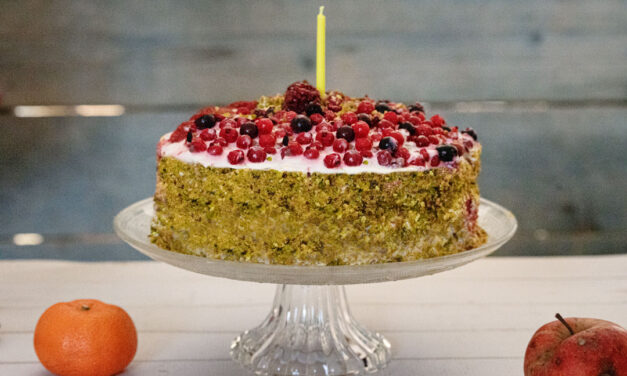 Birthday cake with berries and pistachios